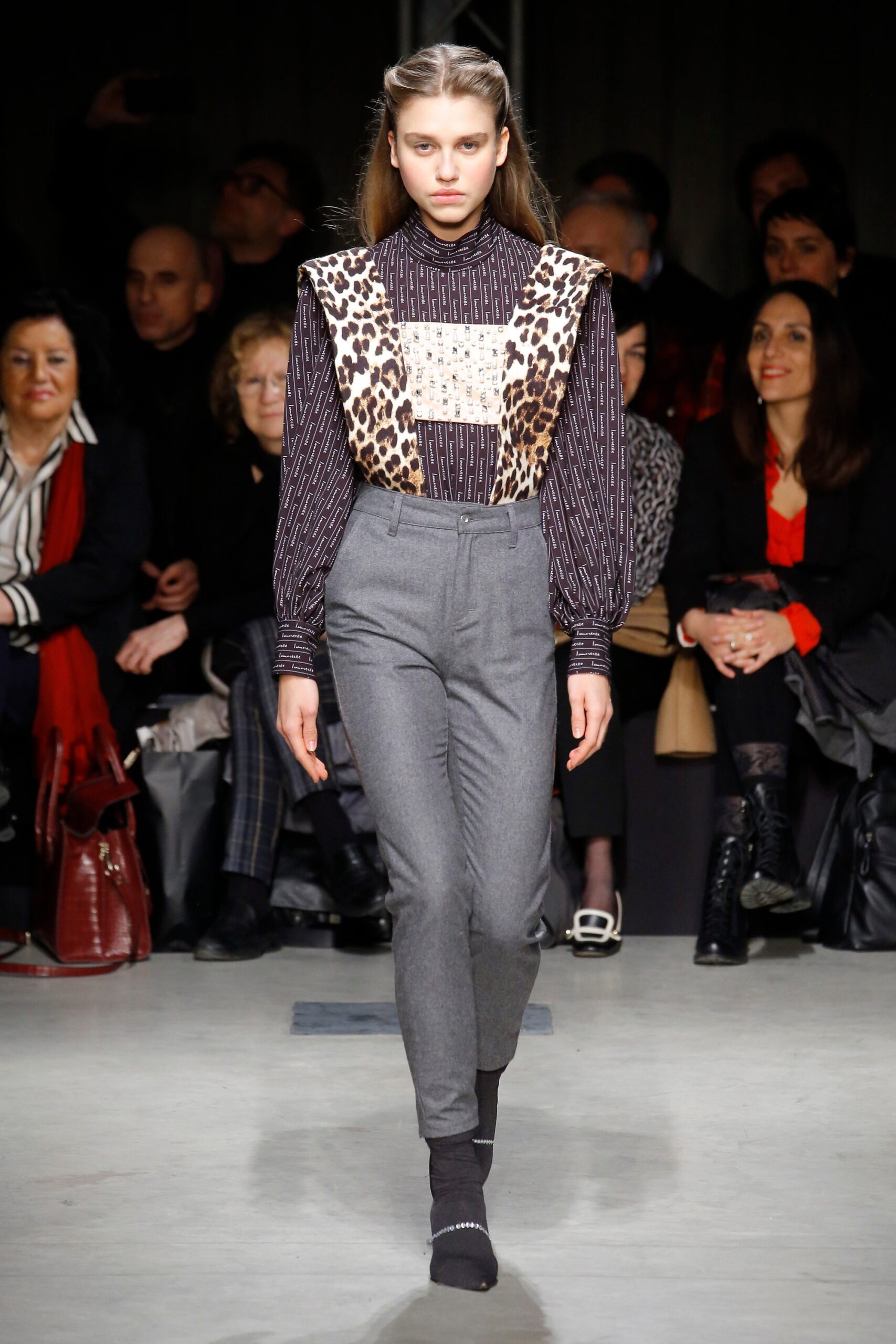fitted black and white printed blouse with tailored gray pants