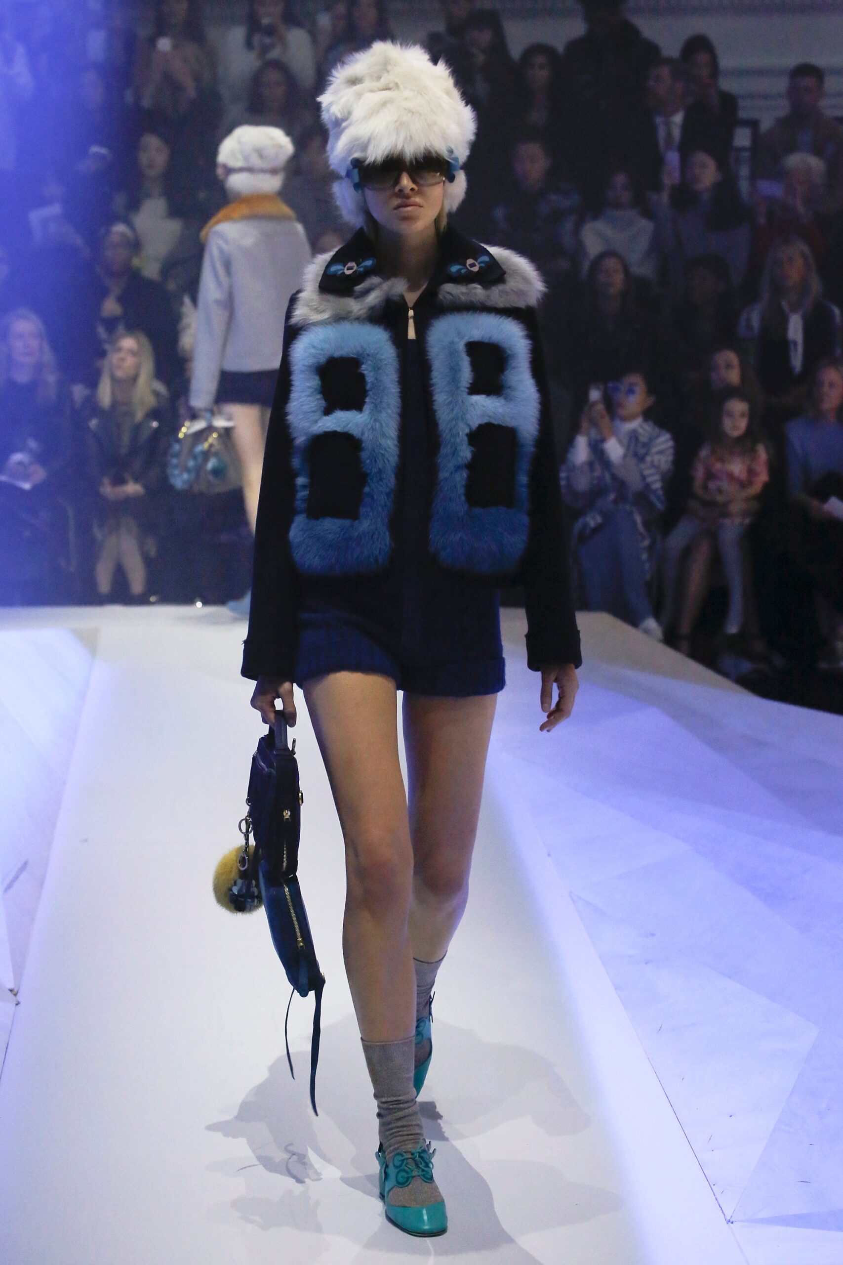 blue faux-fur jacket with denim shorts