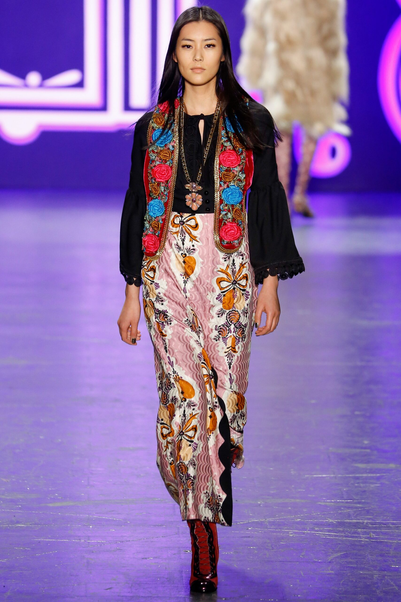 black embroidered blouse and pink flared pants