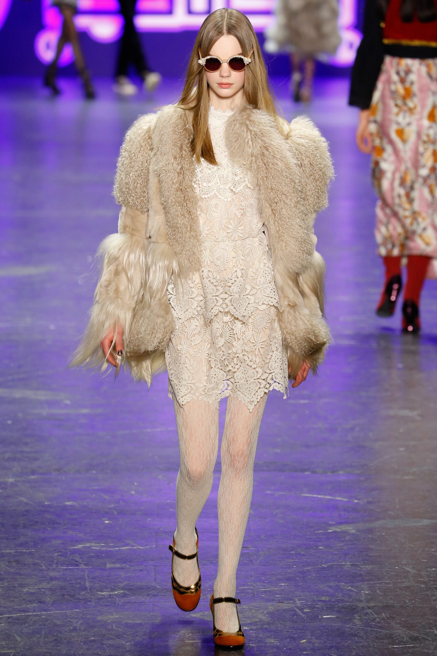 white lace mini dress with beige faux-fur coat
