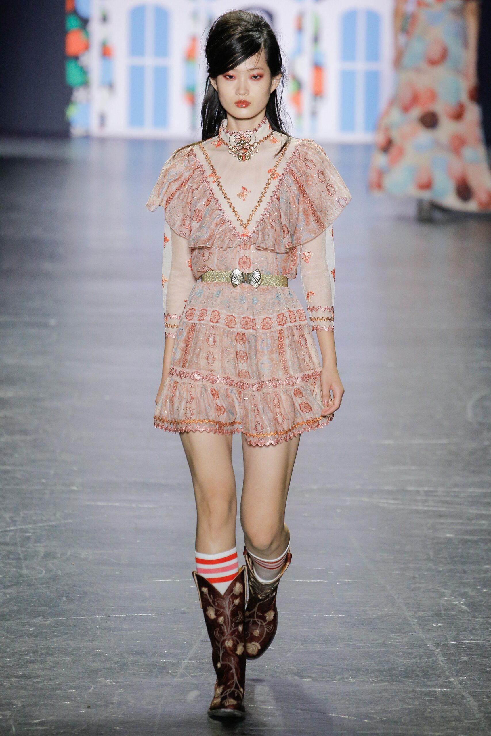 pink ruffled mini dress with brown boots