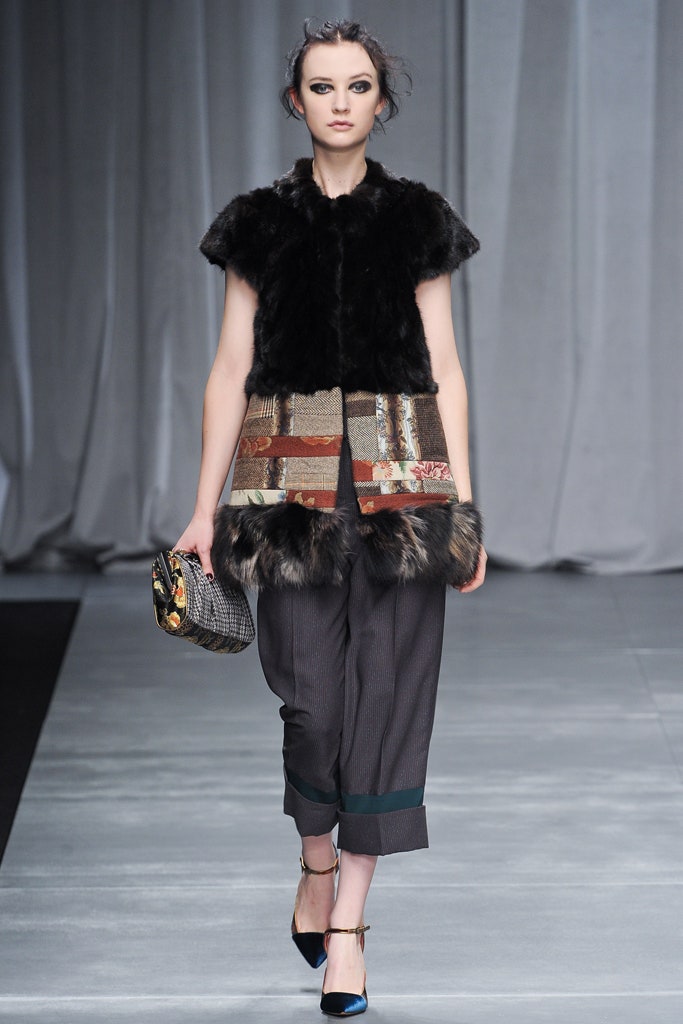 black fur vest with gray pants