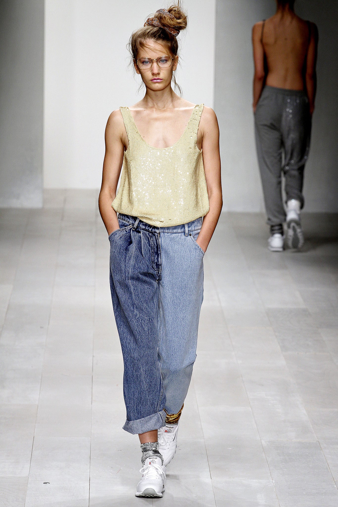 gold silk sleeveless top and denim pants