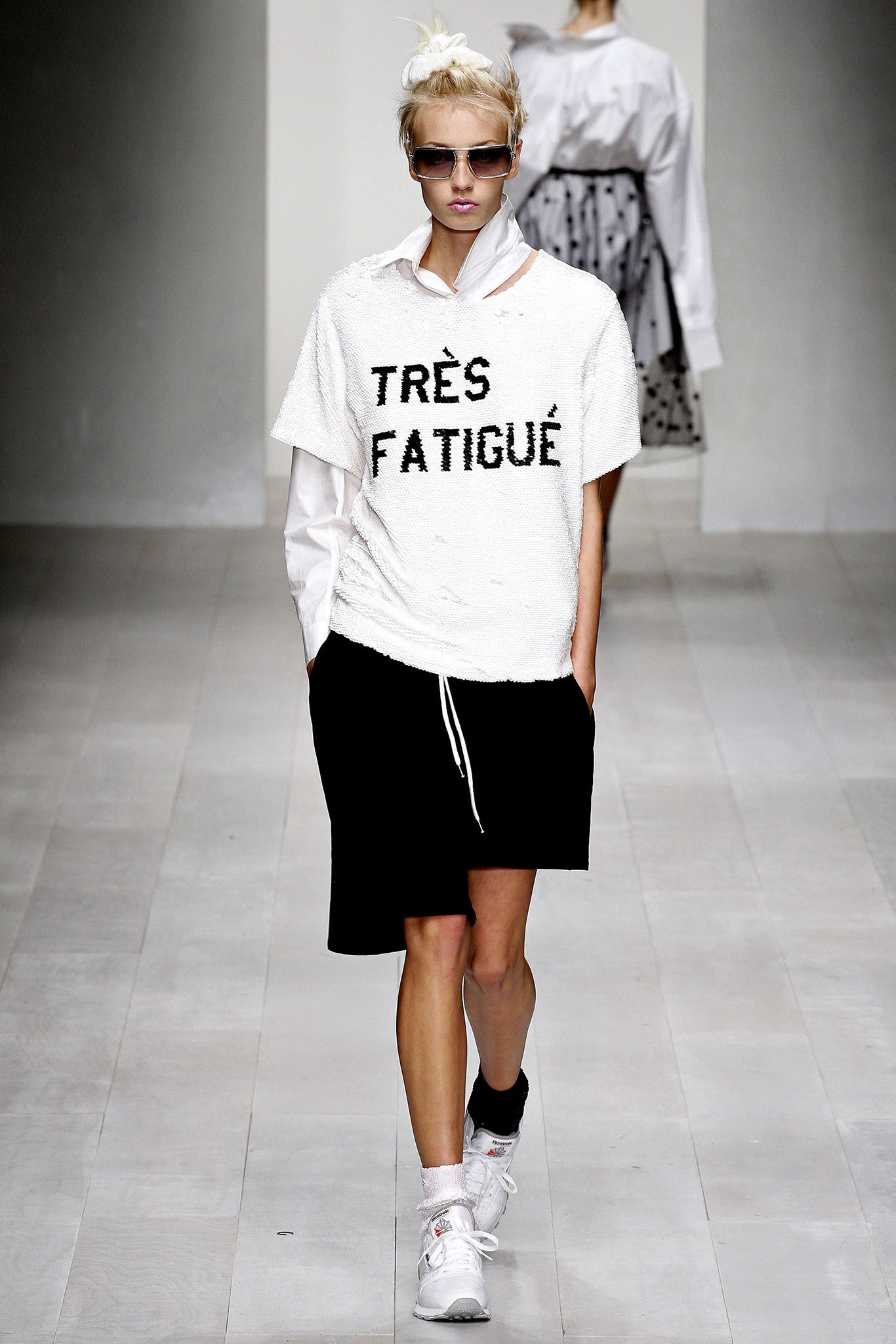 white relaxed top with black shorts