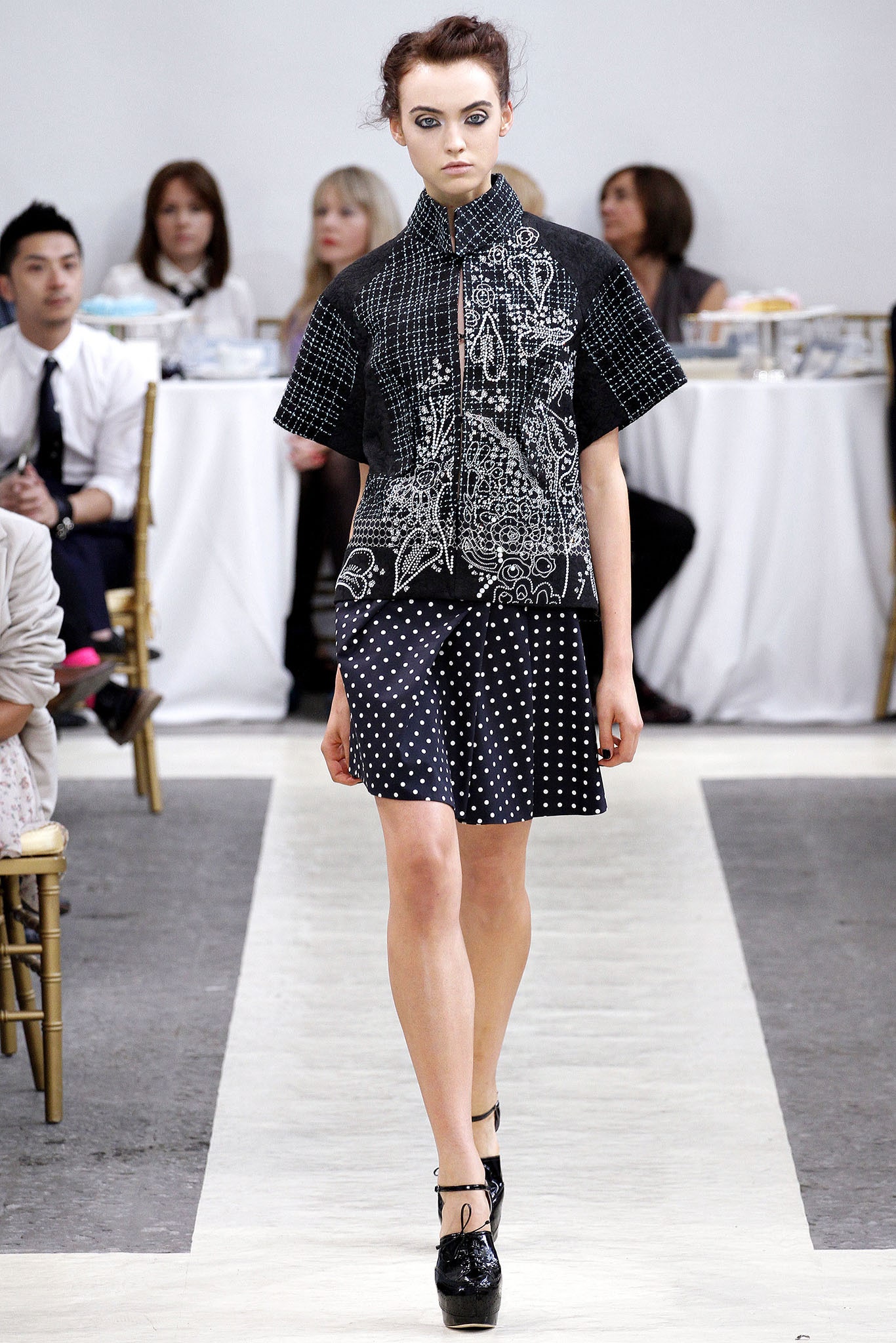 black embroidered top with polka-dot skirt