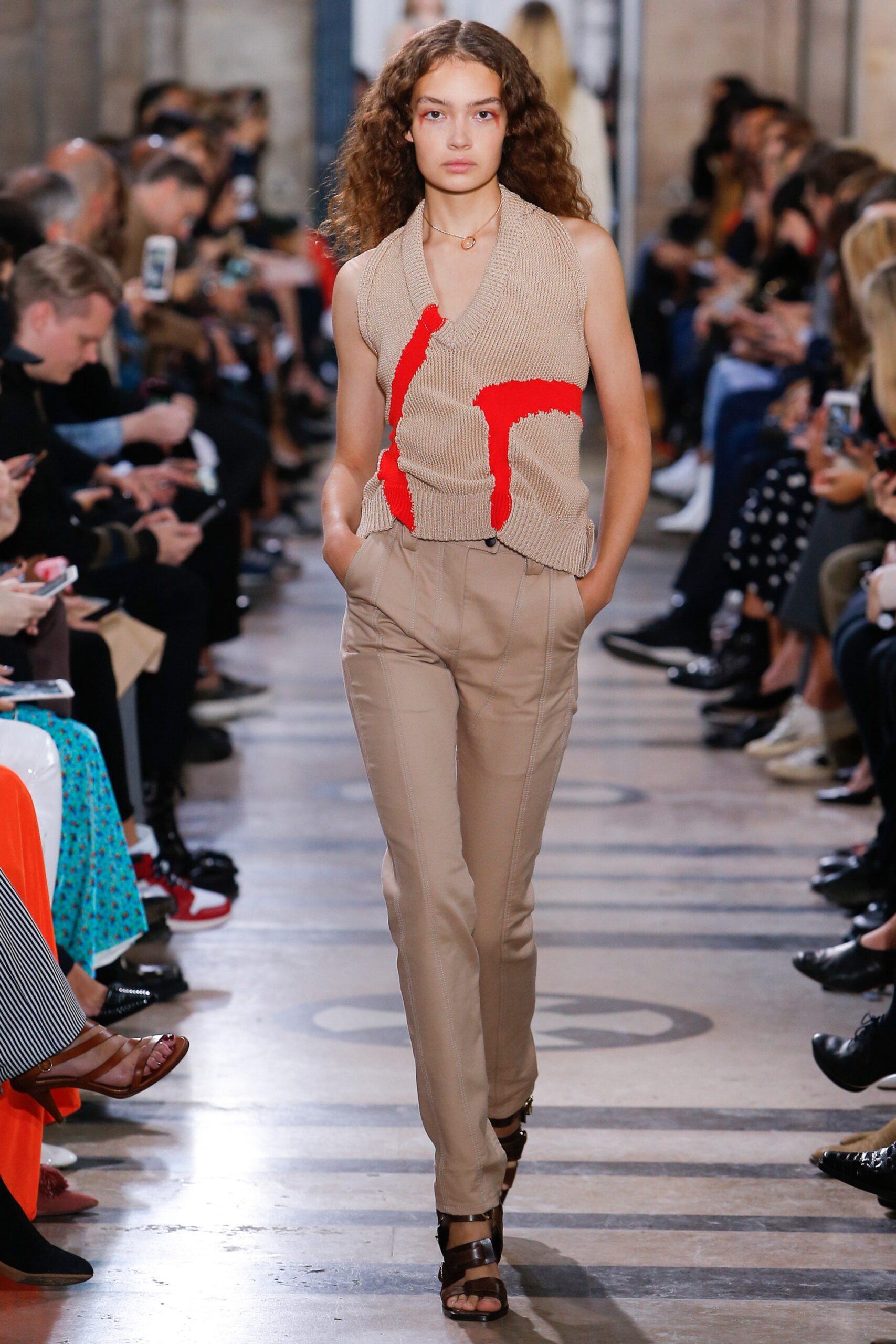 beige fitted top with red accents