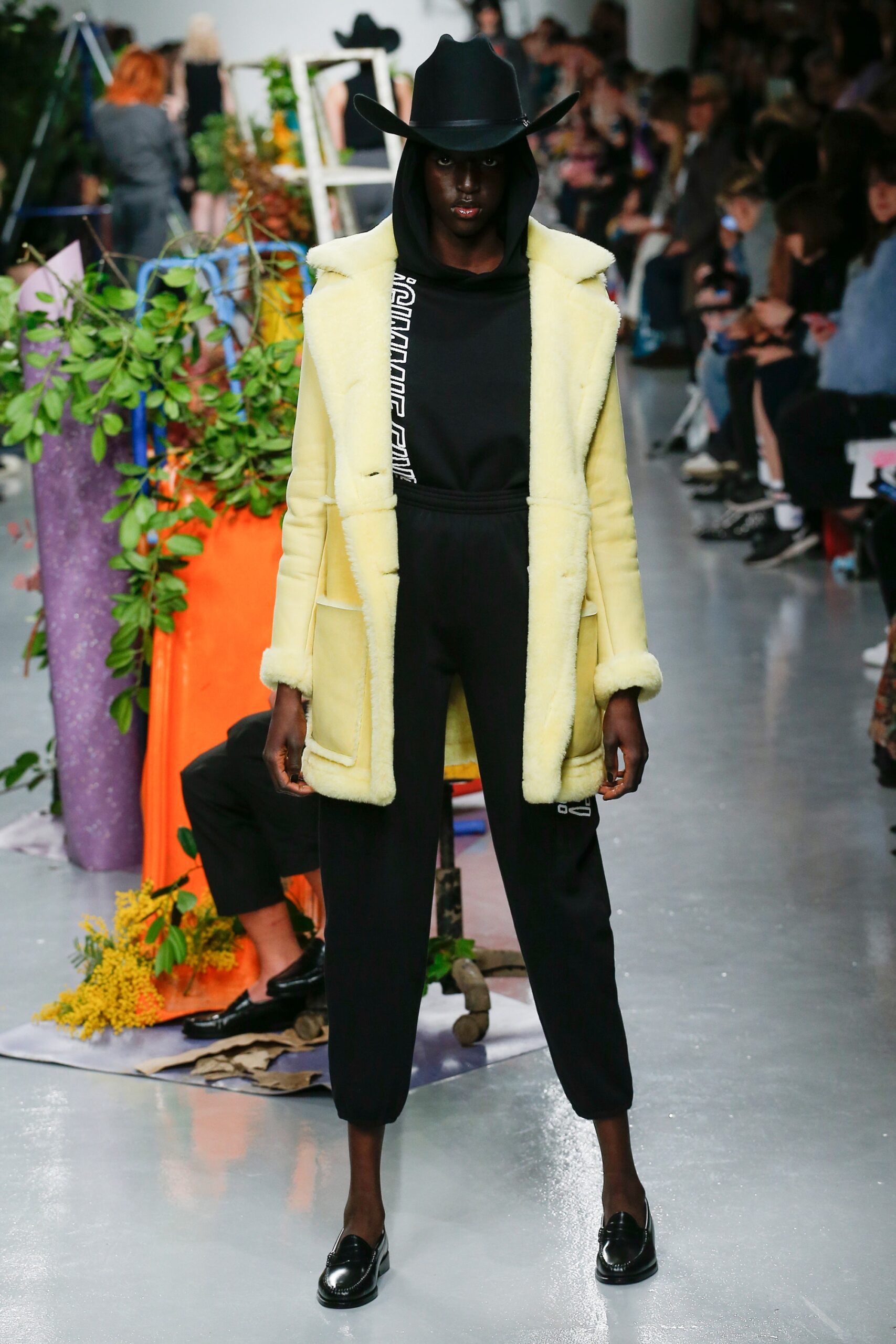 yellow faux-fur coat with black outfit