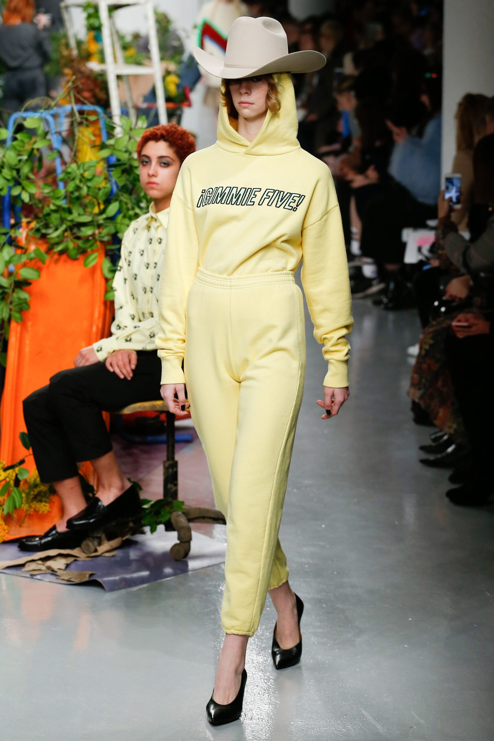 yellow hooded jumpsuit with black shoes