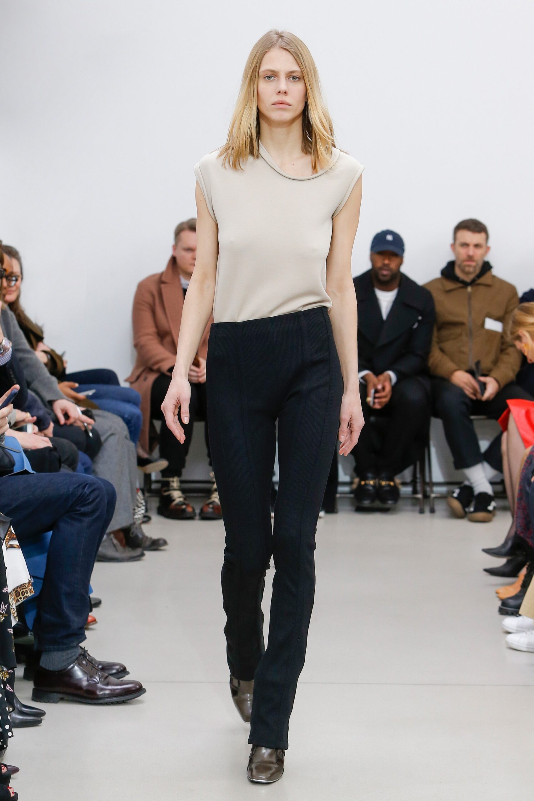beige fitted top black pants