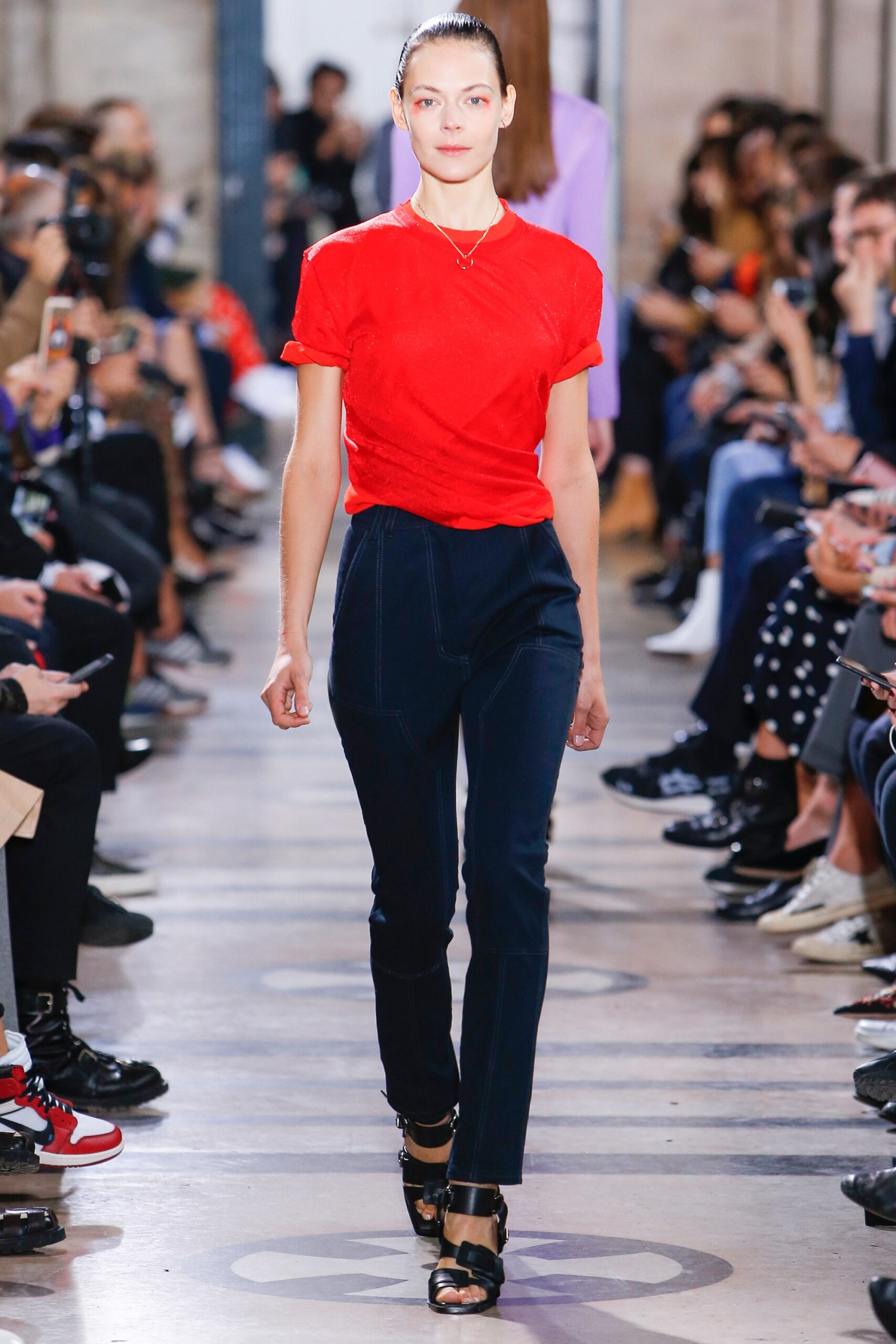 red fitted top with blue pants