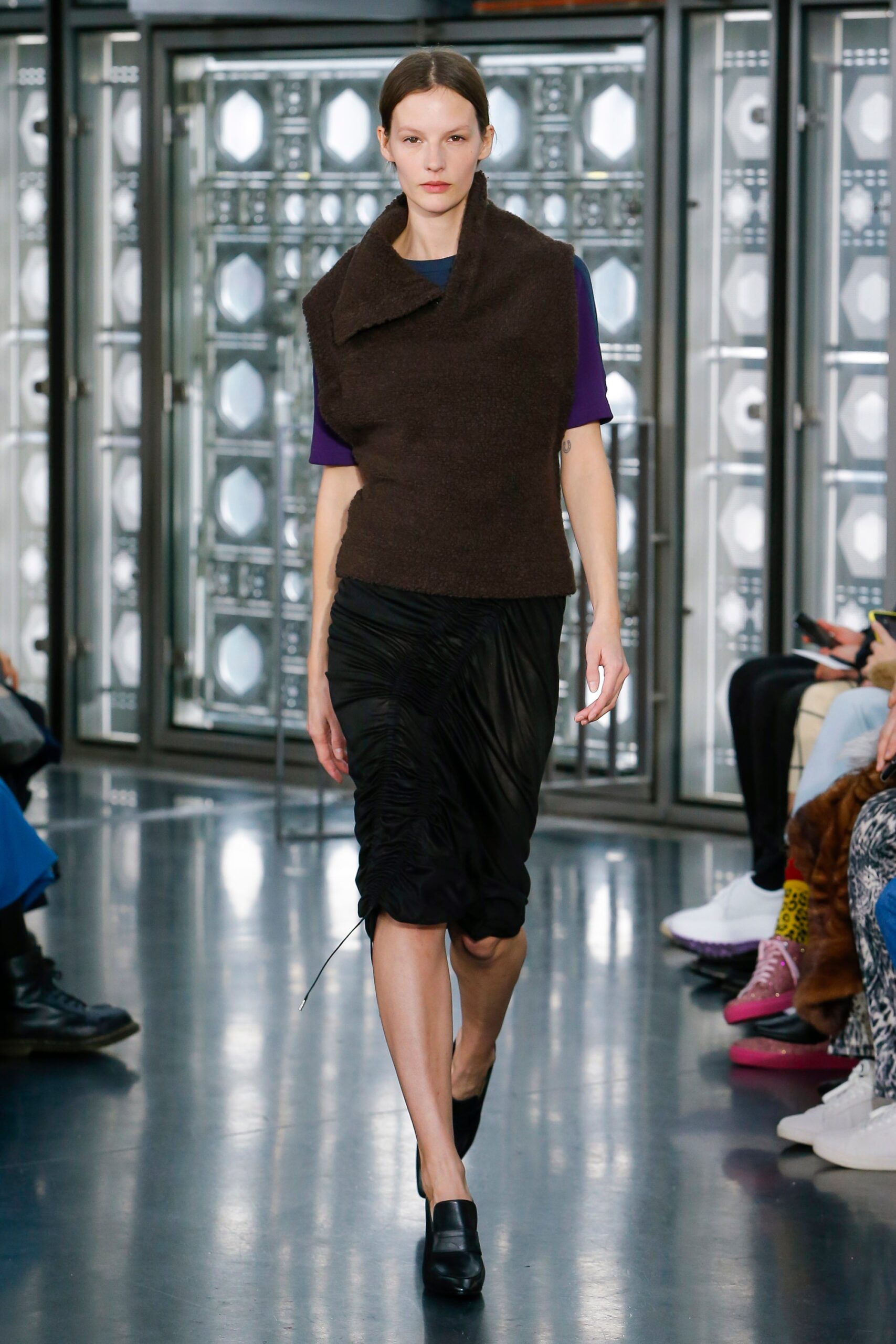brown fitted top and black skirt