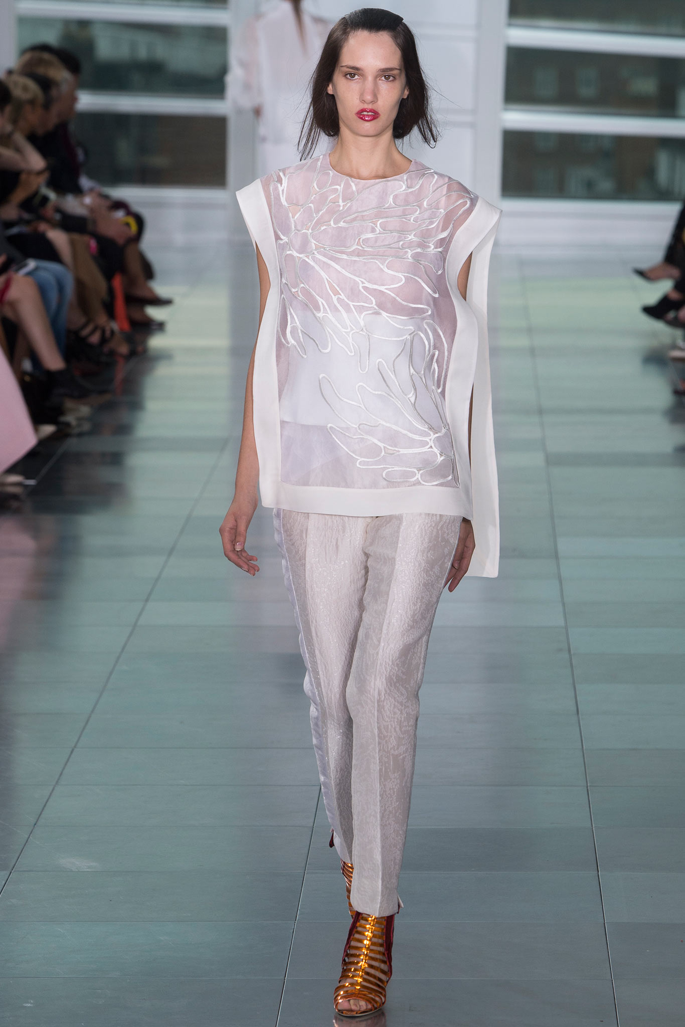 white silk embroidered top with gray pants