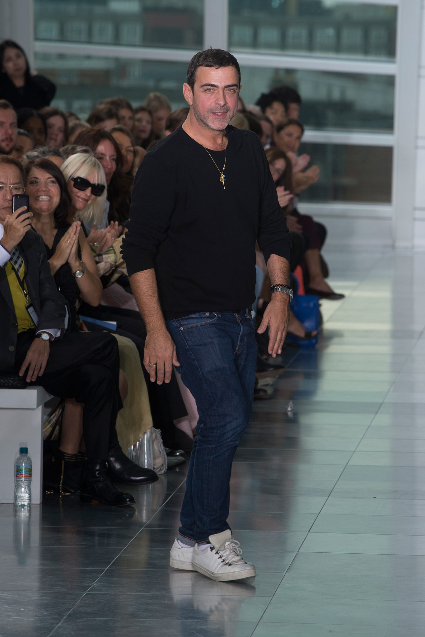 black shirt blue jeans white shoes