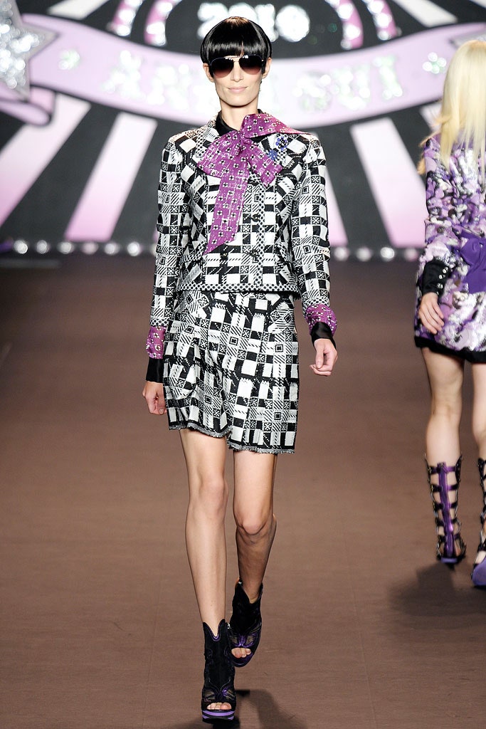 checked shorts and purple blouse