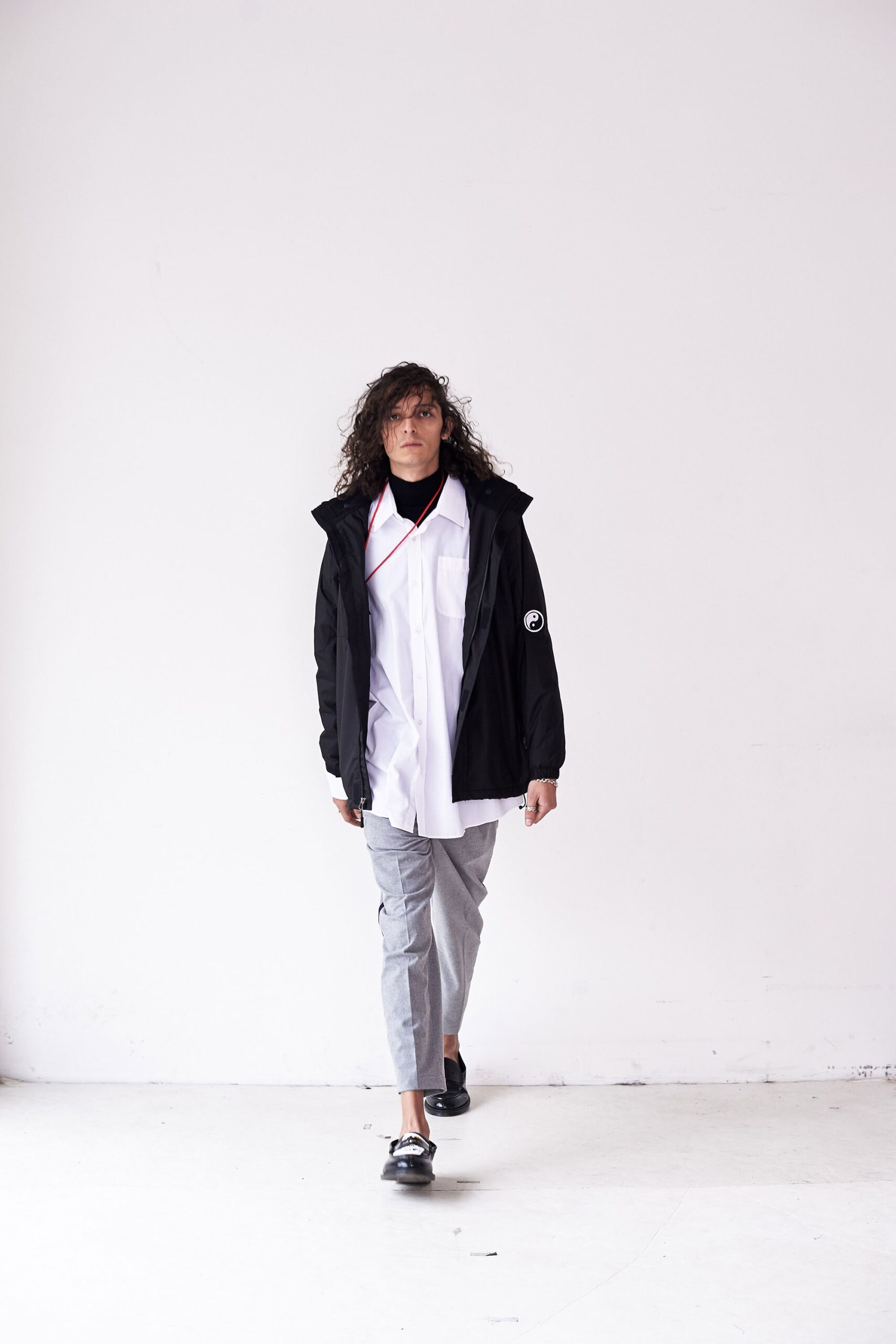 black jacket white shirt gray pants