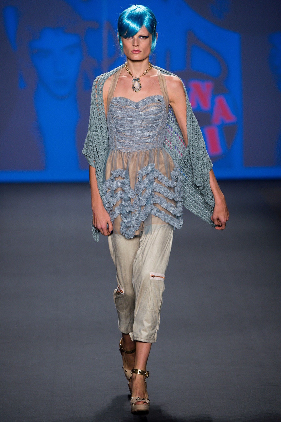 blue ruffled top with beige pants