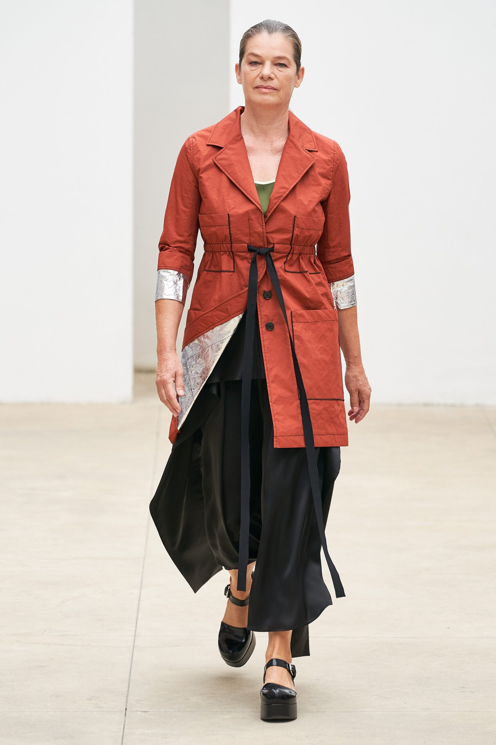 red relaxed coat with black pants