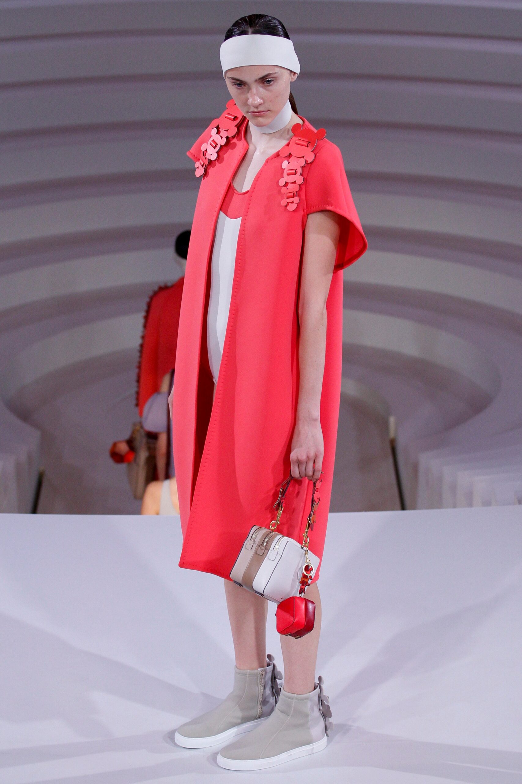 red neoprene cape with white dress