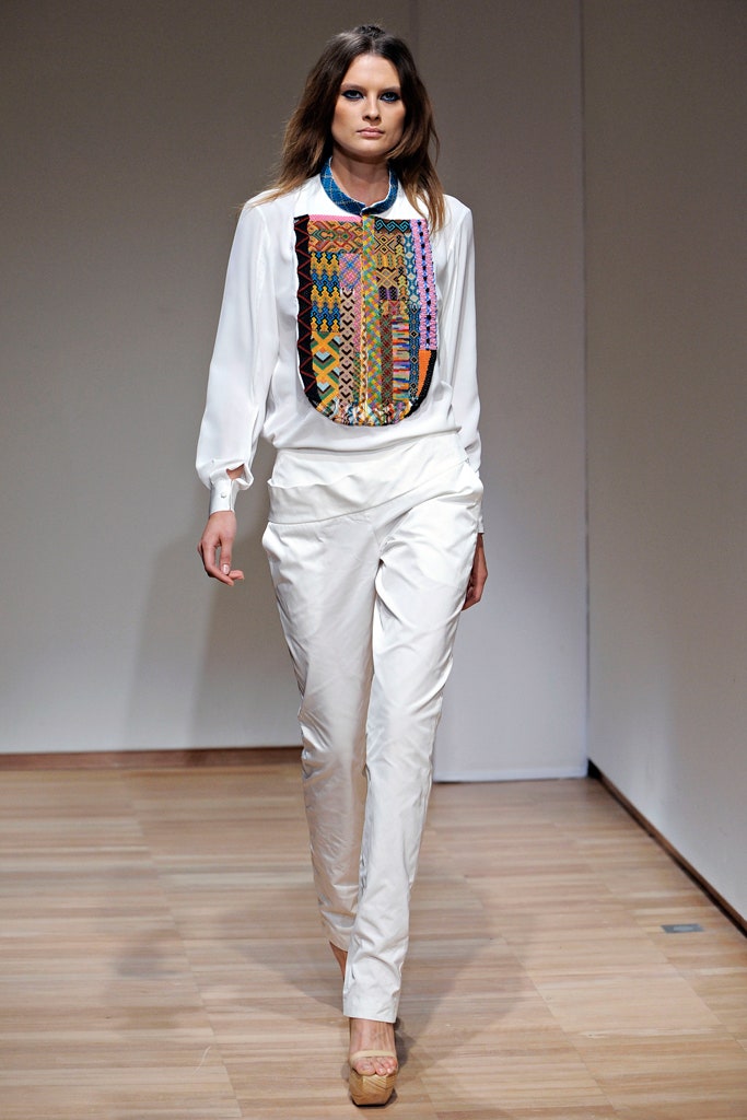 white embroidered shirt and beige pants