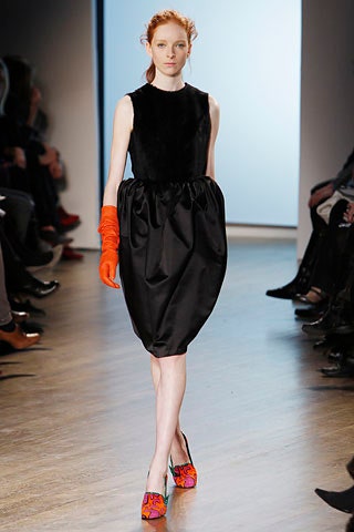 black silk sleeveless dress with orange gloves