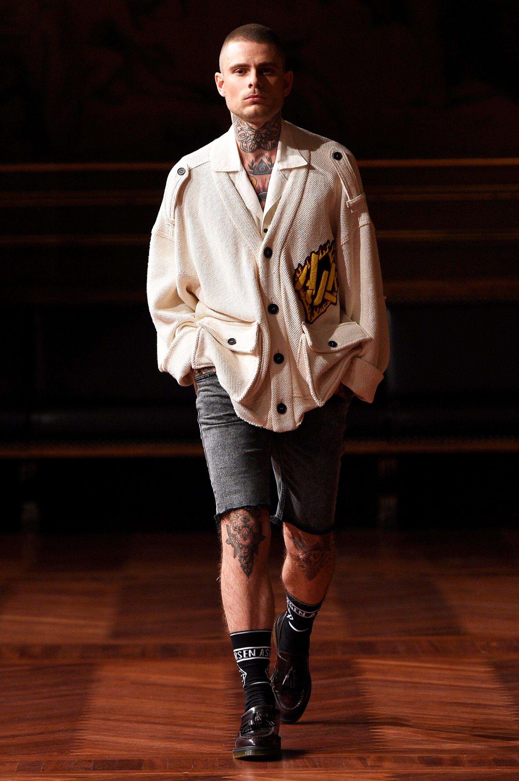 white relaxed jacket with gray shorts