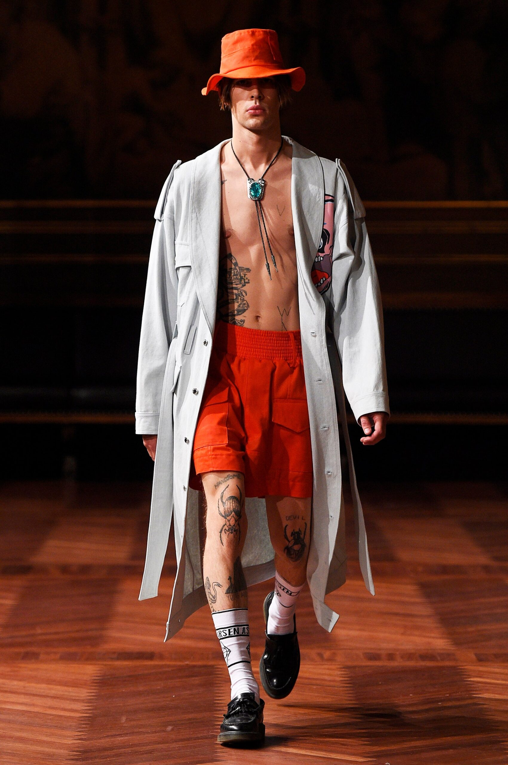 gray coat with orange shorts