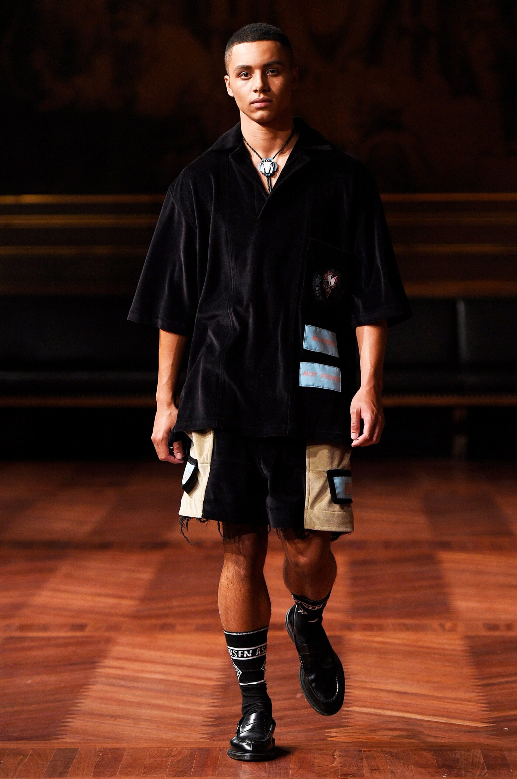 black cotton shirt with beige shorts