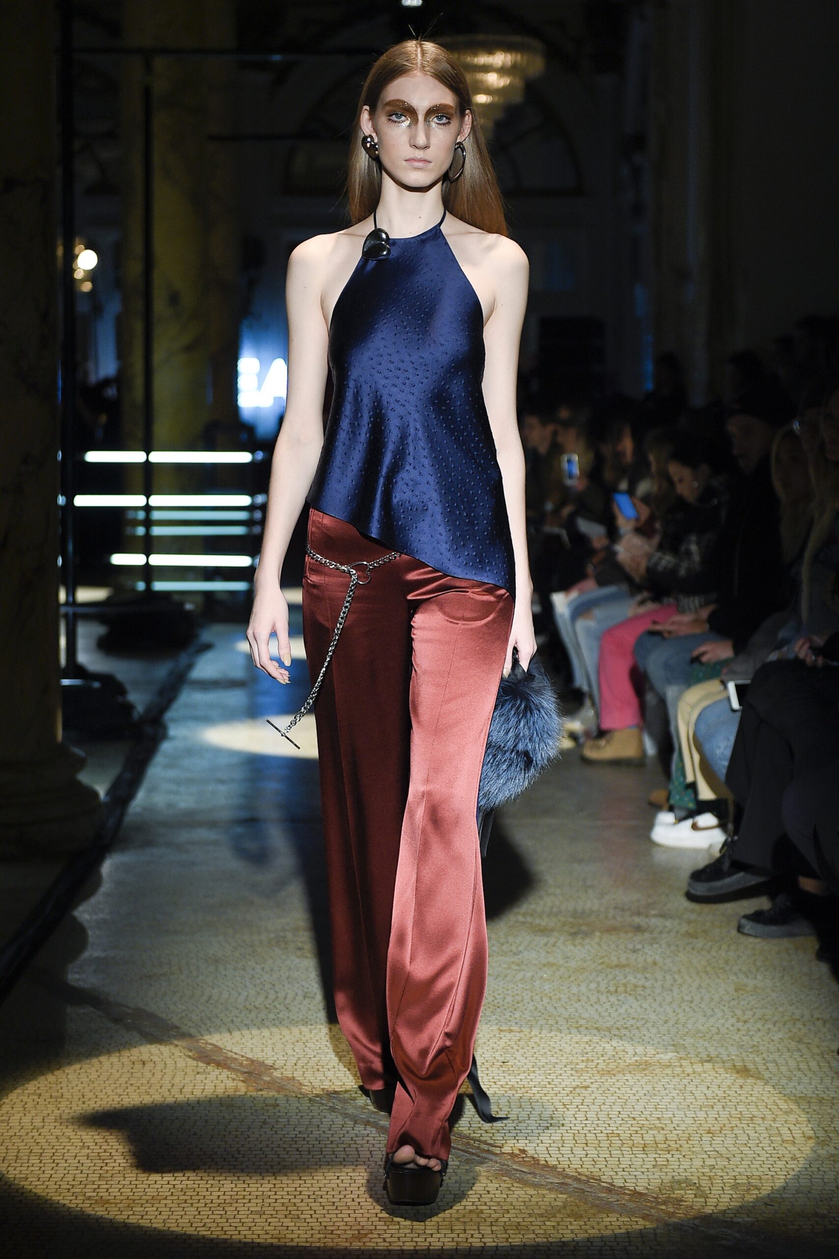 blue silk asymmetric top and red satin pants