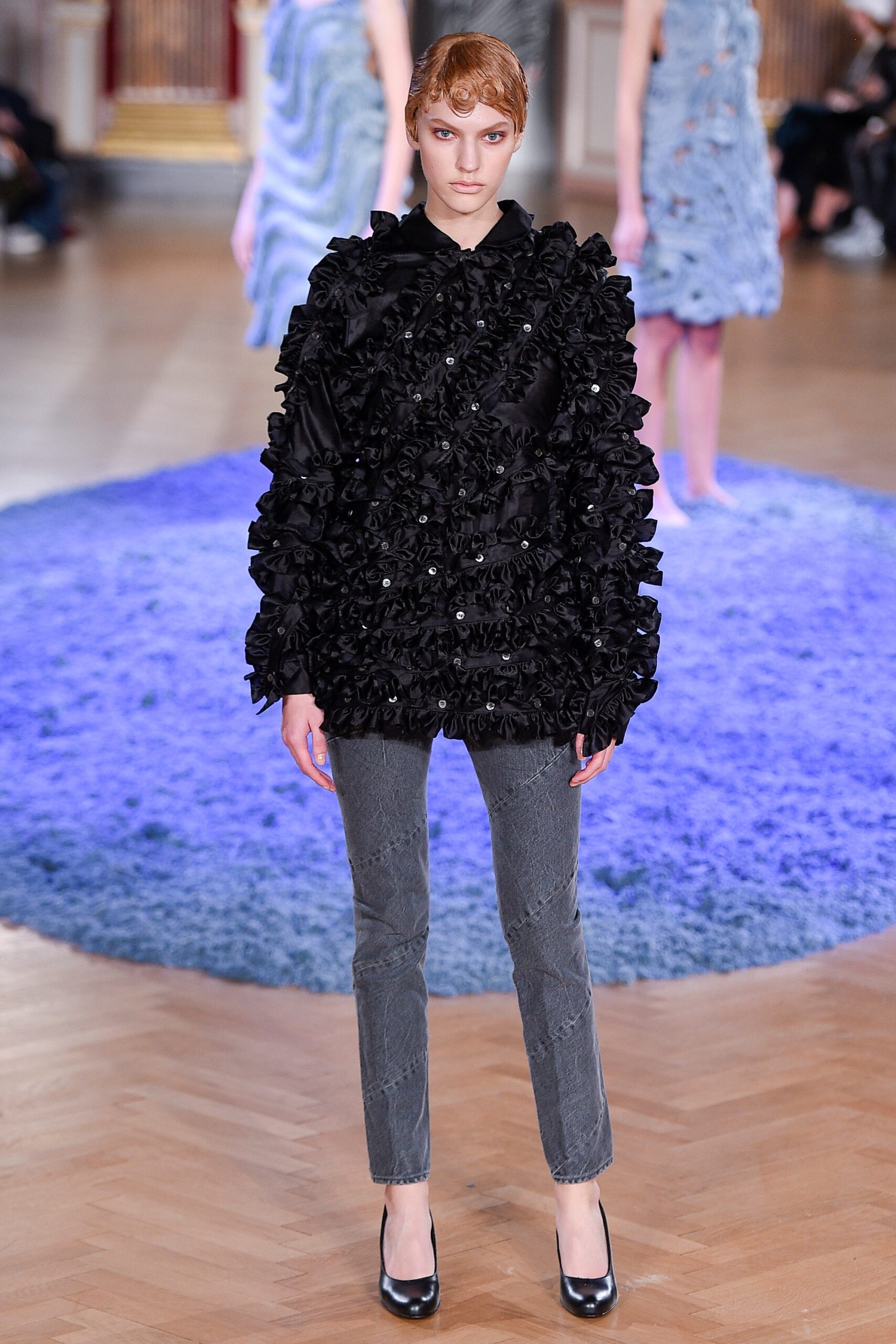 black ruffled jacket with gray pants