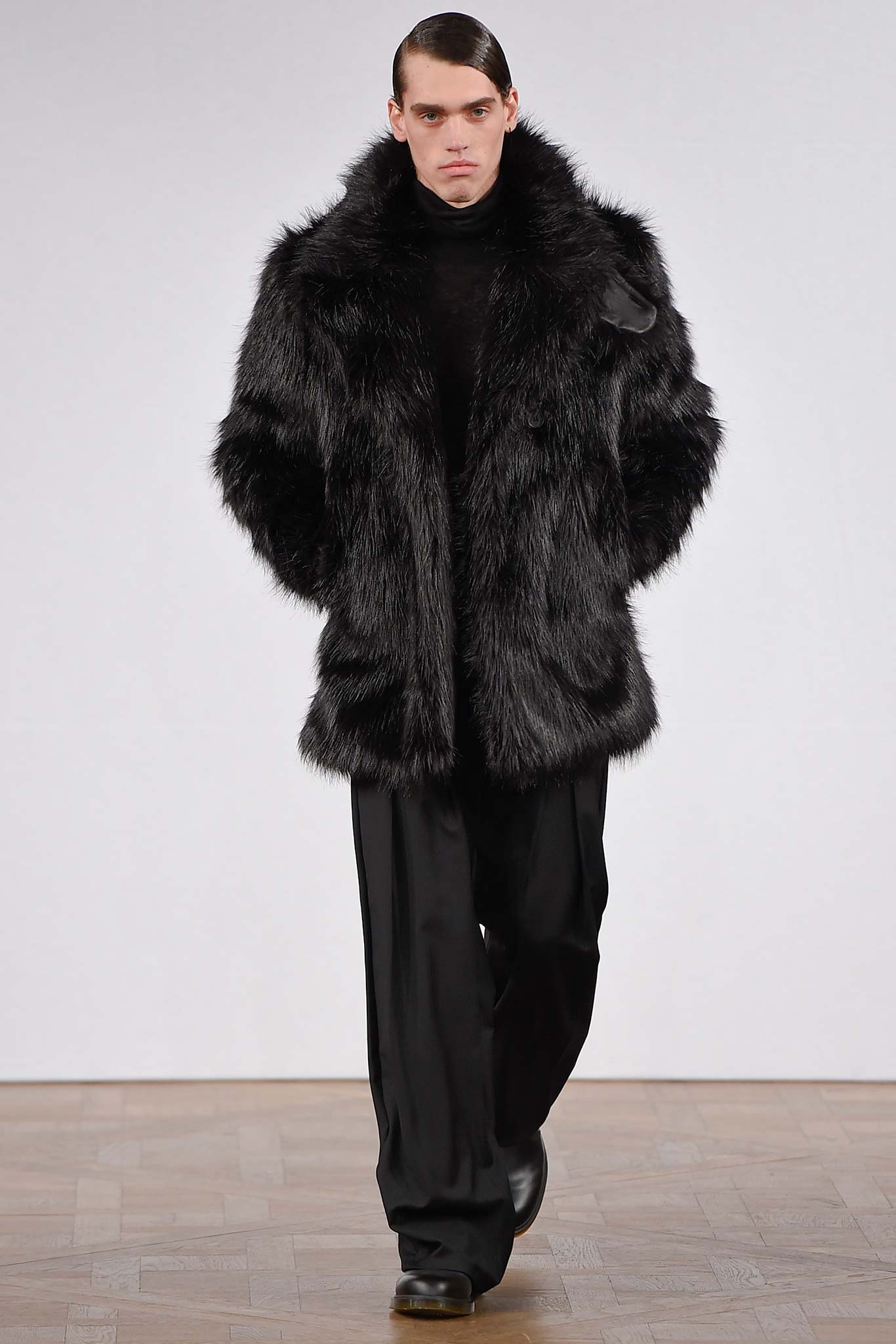 black faux-fur coat and tailored pants