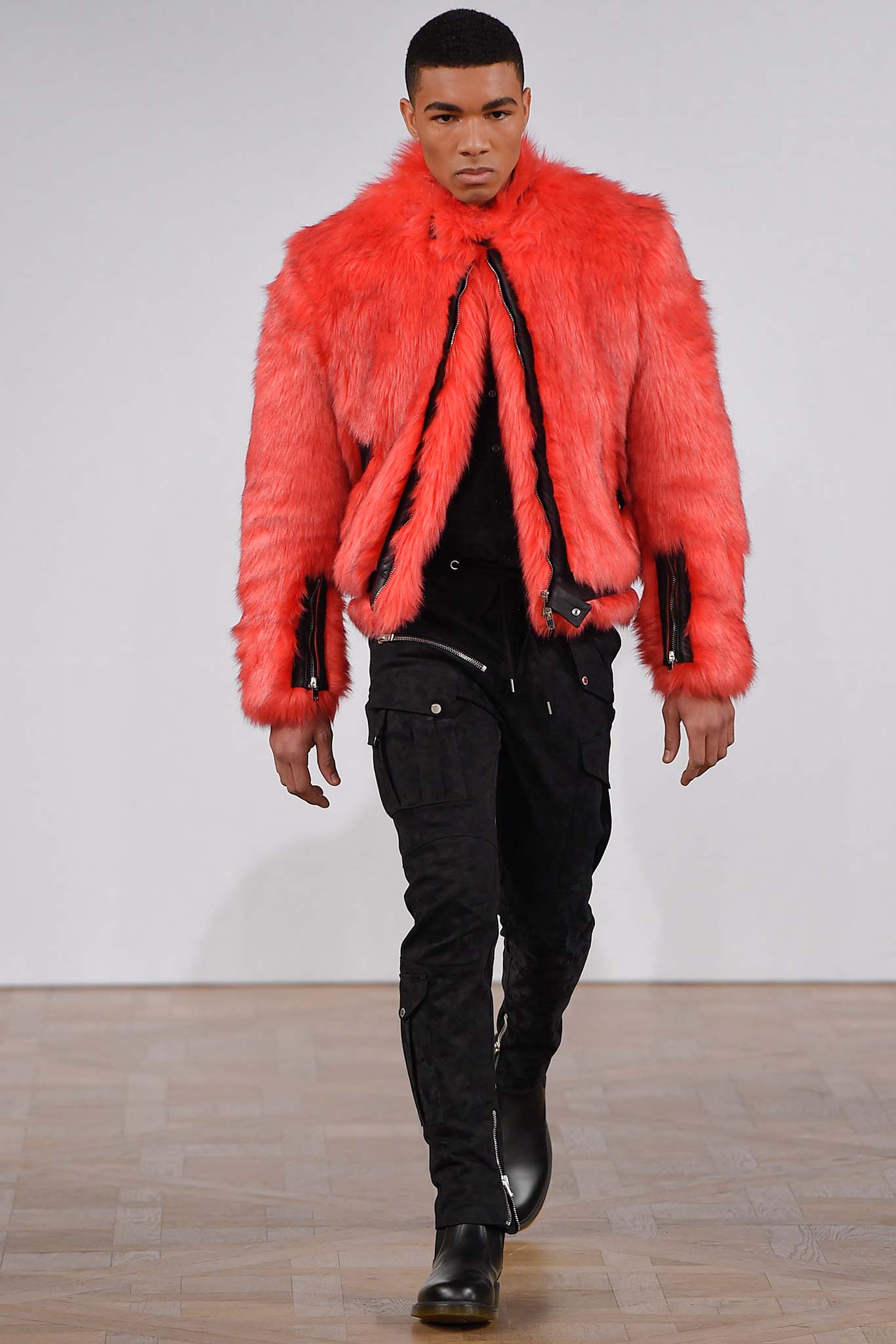 red faux-fur jacket with black pants