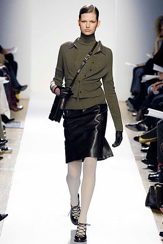 fitted green blouse and black leather skirt