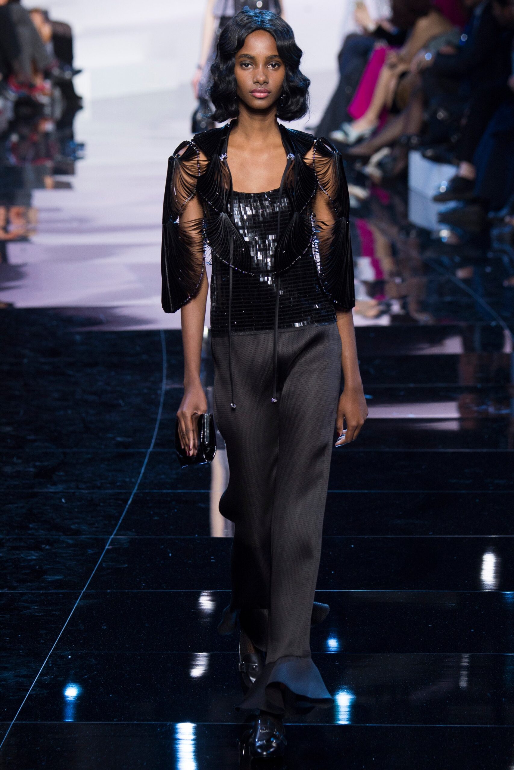 black sequined sleeveless top and flared pants