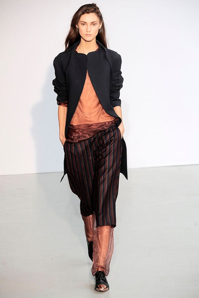 black jacket orange top brown pants