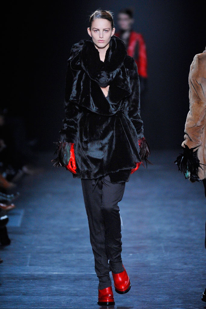 black faux-fur coat with red accessories
