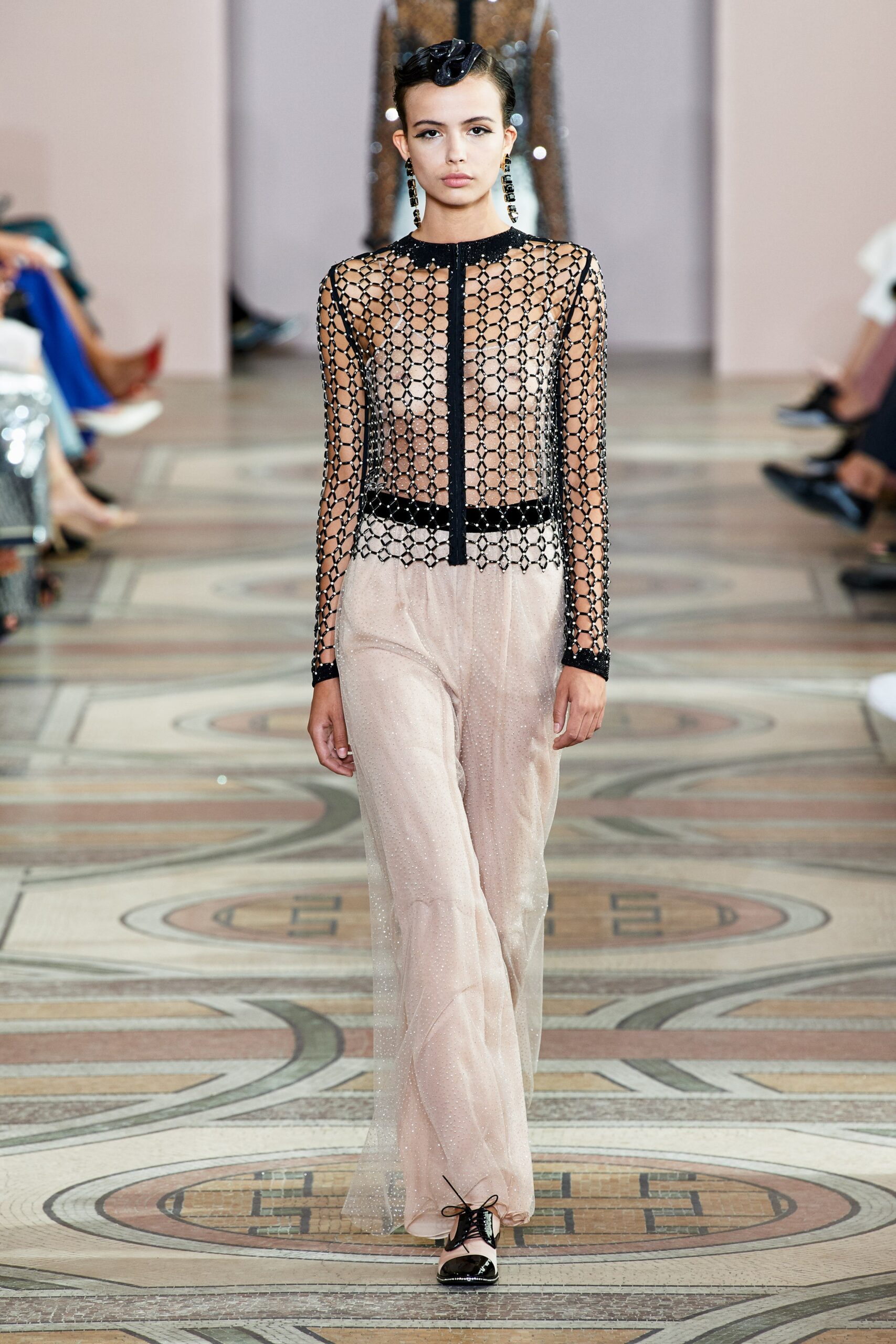 black mesh top with beige pants