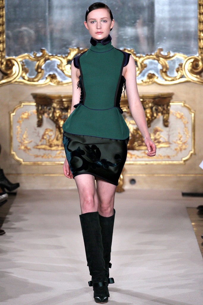 green and black fitted dress with knee-high boots