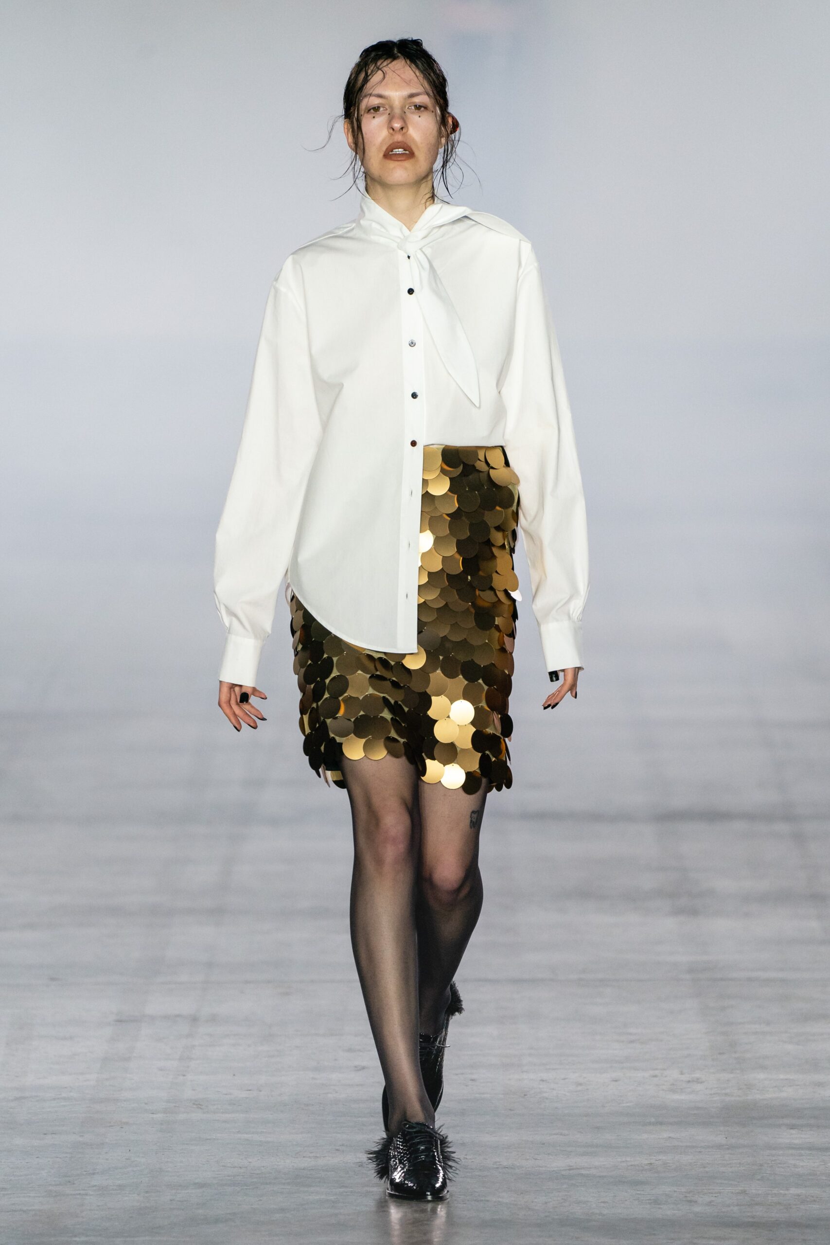 white relaxed shirt with gold skirt