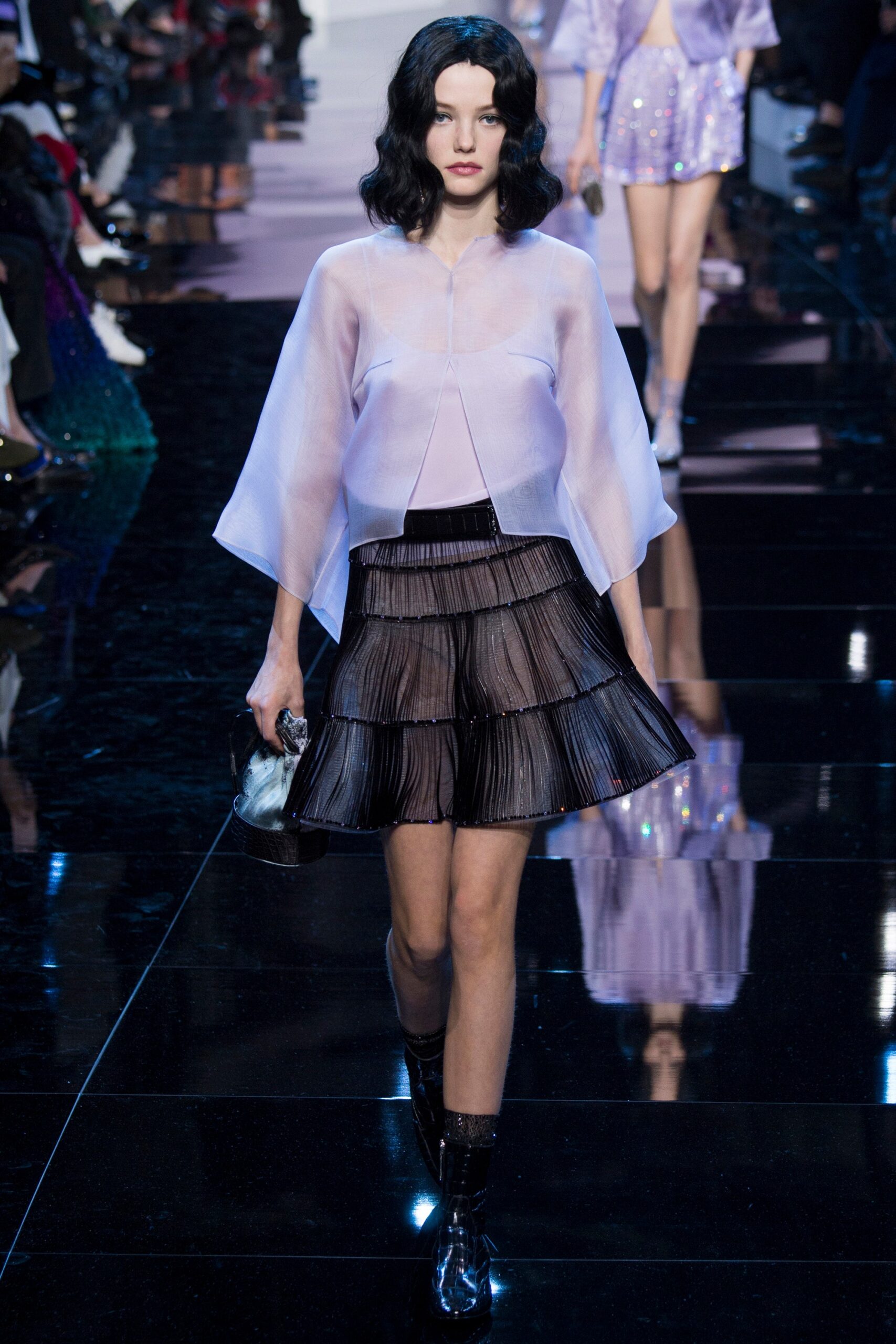 purple silk top and black pleated skirt