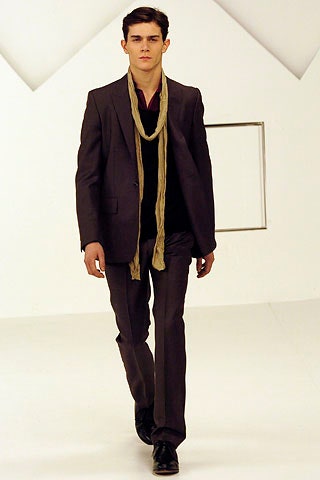 black tailored suit with beige scarf
