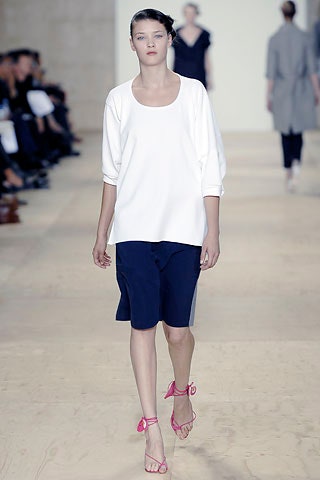 white relaxed top with blue shorts