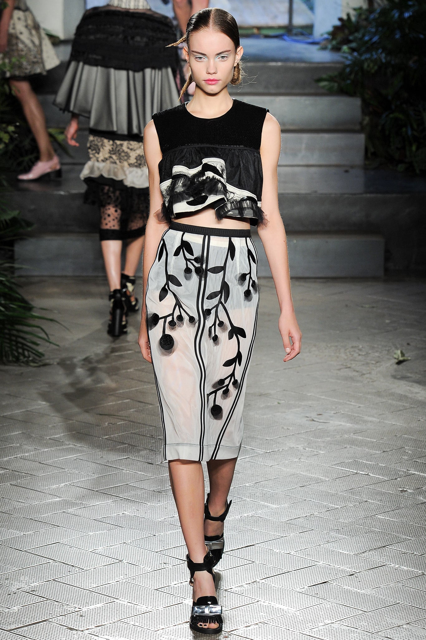 black silk ruffled top and white embroidered skirt