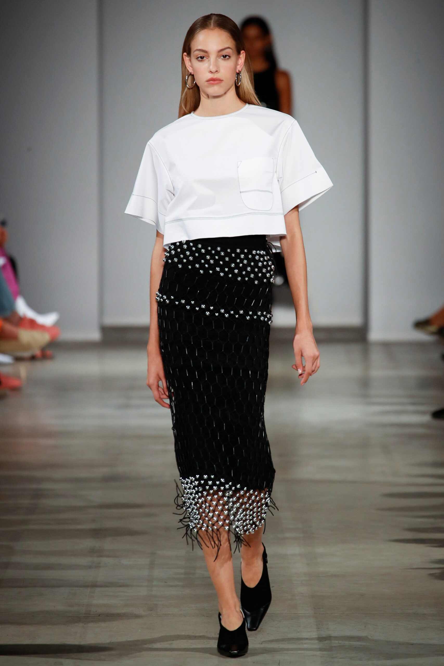 white relaxed top with black skirt