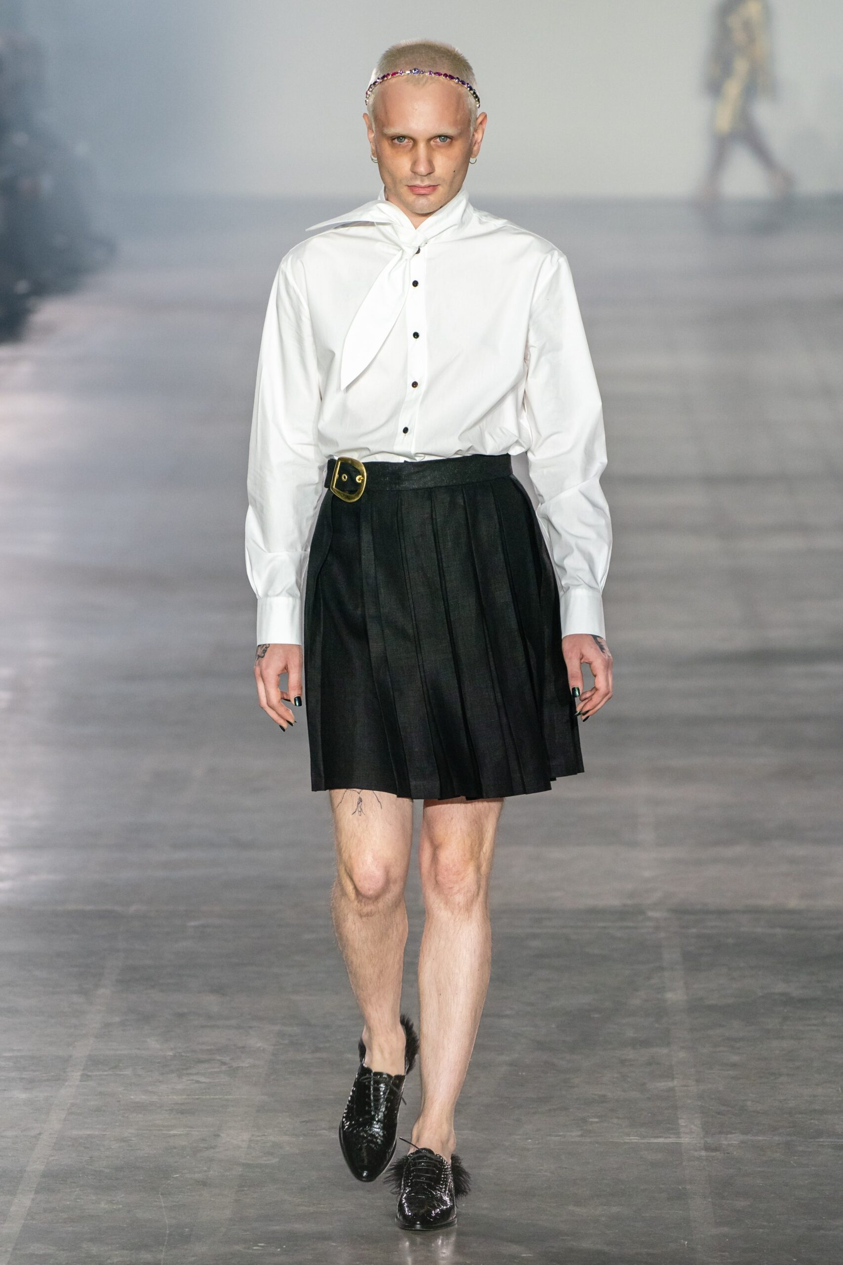 white relaxed shirt and black pleated skirt