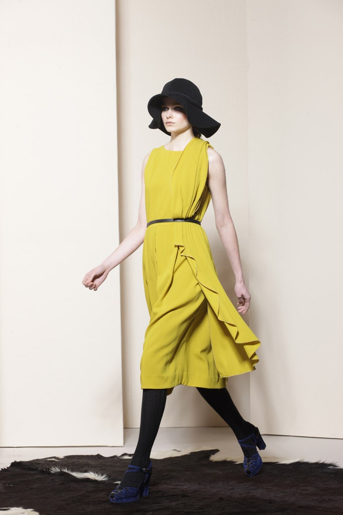 yellow silk midi dress and black hat