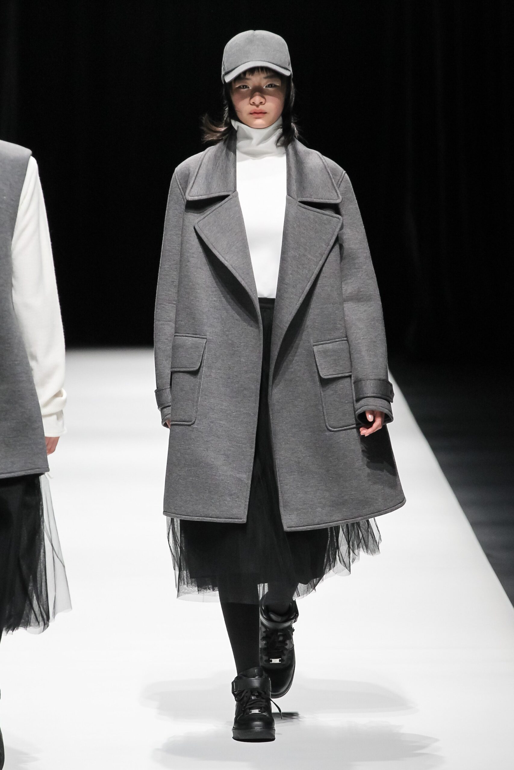 gray wool coat with black tulle skirt