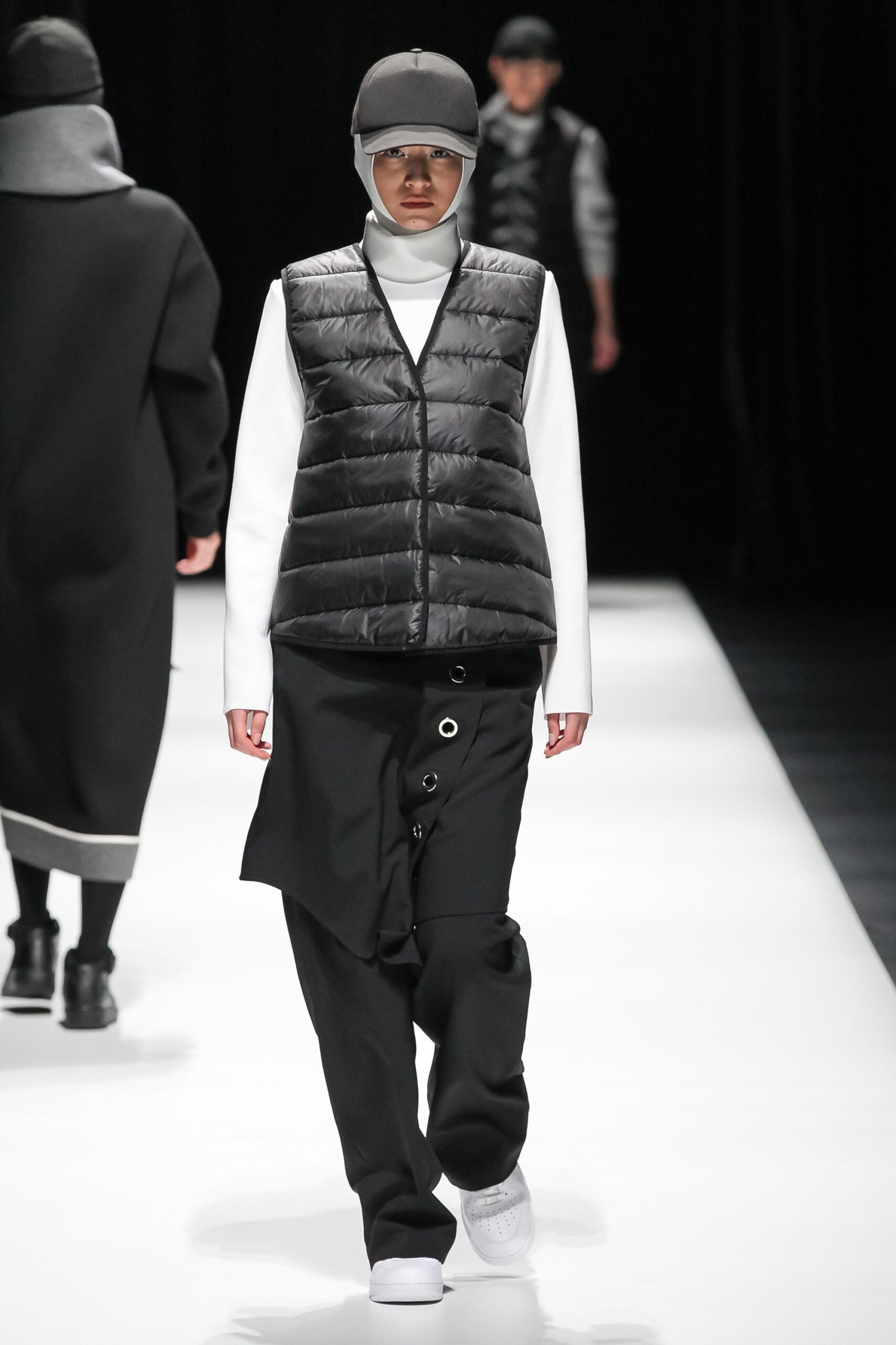 black vest white turtleneck black pants