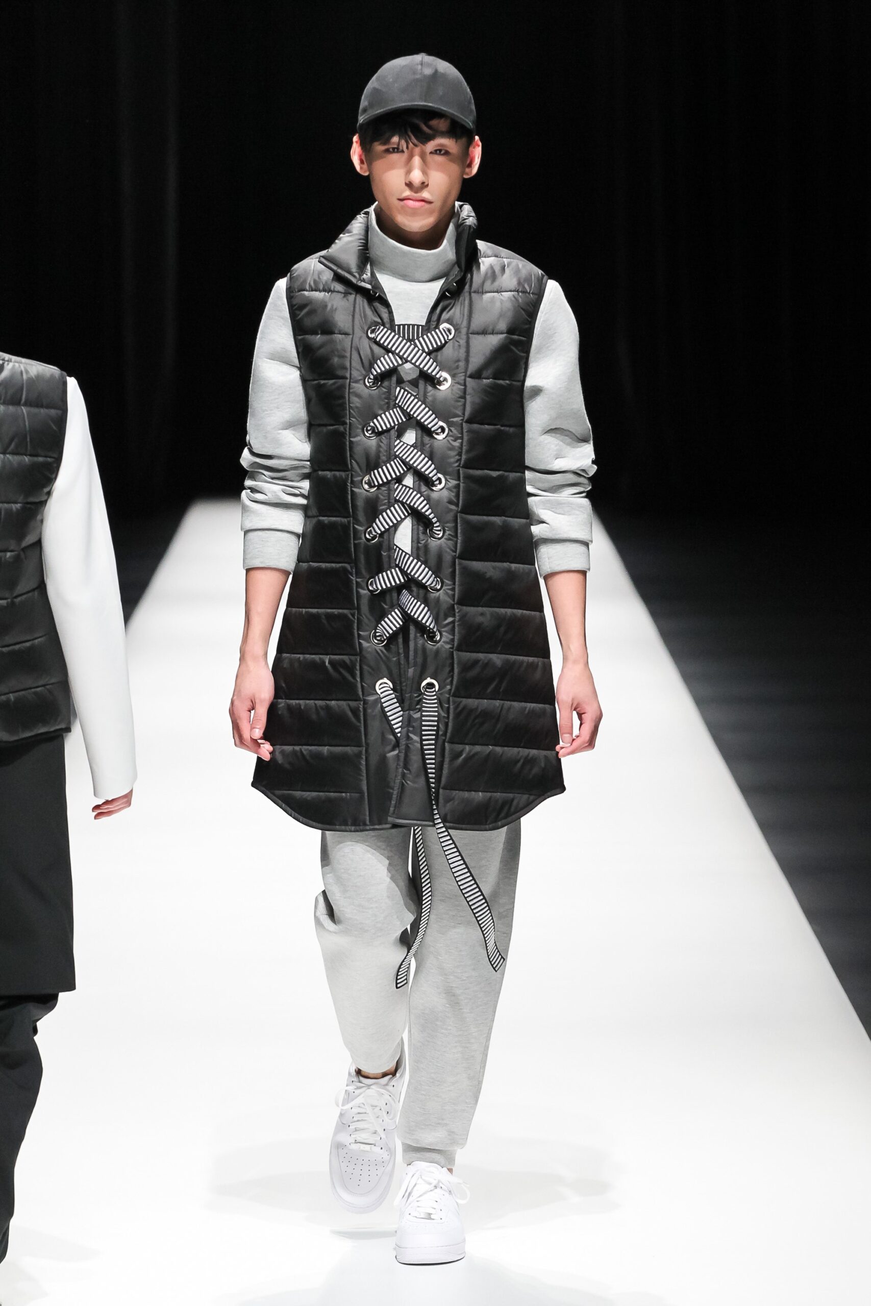 black vinyl coat gray sweater pants