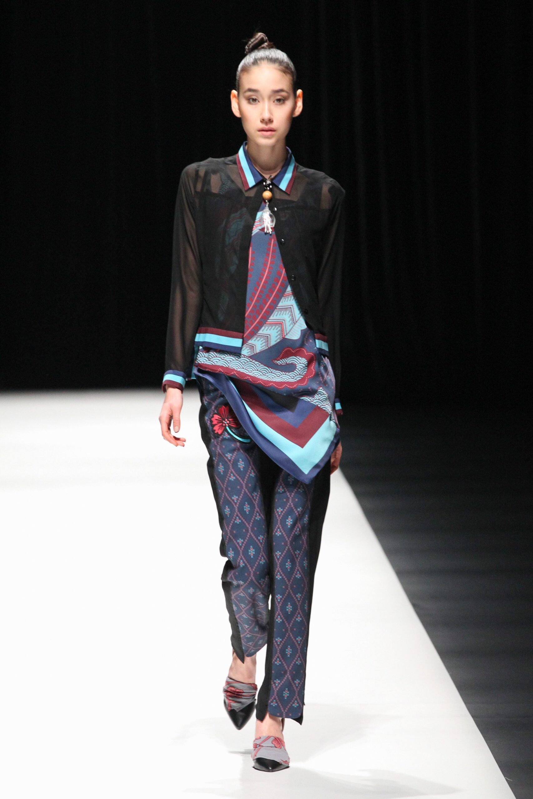 black sheer blouse with blue pants