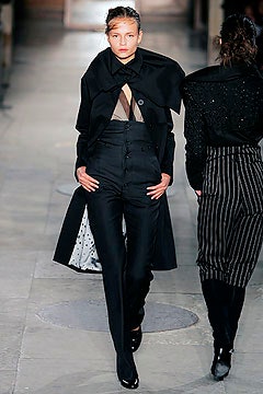 black fitted coat and tailored pants